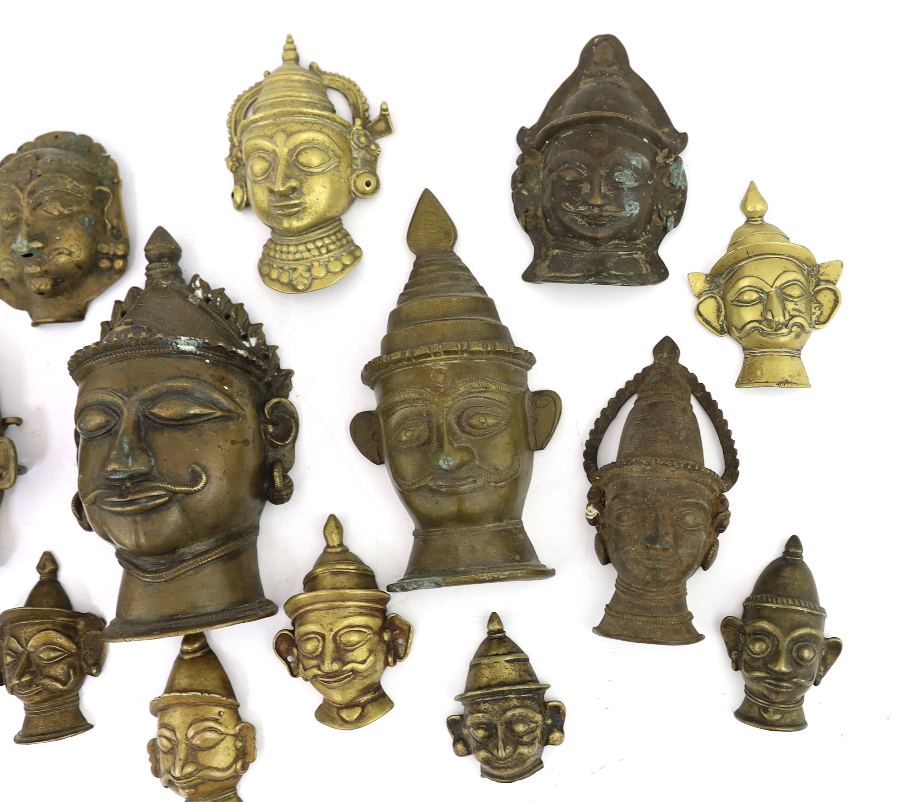 A group of nineteen bronze or brass Shiva masks, Southern India, 16th-19th century, 6.2 - 19.5cm high